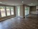 Spacious living room with sliding doors, large windows, and an accent fireplace at 1632 Oleander Sw Dr, Lilburn, GA 30047