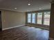 Large room with hardwood floors and bright windows with a view to the outside at 1632 Oleander Sw Dr, Lilburn, GA 30047
