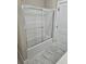 Modern shower/tub combo with a glass enclosure, offering a sleek and clean bathroom design at 1632 Oleander Sw Dr, Lilburn, GA 30047