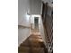 Wooden staircase with stylish railings, illuminated by sconces, leads to the upper level of the home at 1632 Oleander Sw Dr, Lilburn, GA 30047