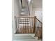 Elegant staircase with wooden handrails and iron spindles, complemented by recessed lighting for a stylish look at 1632 Oleander Sw Dr, Lilburn, GA 30047