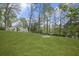 Expansive backyard featuring lush green grass and mature trees, perfect for outdoor activities and relaxation at 1670 Nordic Trce, Marietta, GA 30068