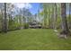 View of lush green backyard and home in background at 1670 Nordic Trce, Marietta, GA 30068