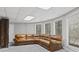 A basement features carpet flooring, multiple windows for natural light, and a large brown leather couch at 1670 Nordic Trce, Marietta, GA 30068