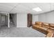 A basement featuring carpet flooring, stairs, large windows for natural light, and a comfortable leather couch at 1670 Nordic Trce, Marietta, GA 30068