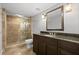 Tiled bathroom featuring a glass enclosed shower and dark brown vanity with granite countertop at 1670 Nordic Trce, Marietta, GA 30068