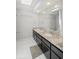 A bathroom features a long granite vanity, white tiled floors, and a large mirror at 1670 Nordic Trce, Marietta, GA 30068