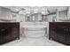 A bathroom featuring double vanities, a soaking tub, modern finishes, and luxurious chandelier lighting at 1670 Nordic Trce, Marietta, GA 30068
