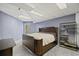 A bedroom features carpet flooring, blue paneled walls, a queen bed, and a sleek shelving unit at 1670 Nordic Trce, Marietta, GA 30068