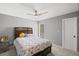 A bedroom features neutral walls, carpet flooring, ceiling fan, queen bed, and natural light at 1670 Nordic Trce, Marietta, GA 30068