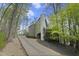 View of home surrounded by trees and a long driveway at 1670 Nordic Trce, Marietta, GA 30068