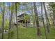 View of the home exterior surrounded by lush trees and greenery with a screened in porch at 1670 Nordic Trce, Marietta, GA 30068