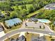 Aerial view of community pool, tennis courts, clubhouse, and surrounding landscape at 127 Crest Brooke Dr, Canton, GA 30115