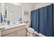 Cozy bathroom featuring a vanity with neutral cabinets and a shower with a blue shower curtain at 127 Crest Brooke Dr, Canton, GA 30115