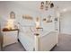 A bedroom with white furniture, warm lighting, and decorations creating a cozy and inviting atmosphere at 127 Crest Brooke Dr, Canton, GA 30115