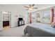 Light-filled bedroom with en-suite bathroom access, large windows and a ceiling fan at 127 Crest Brooke Dr, Canton, GA 30115