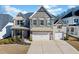 Charming home featuring a stone facade, two-car garage, and inviting front porch at 127 Crest Brooke Dr, Canton, GA 30115