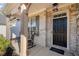 Inviting front entry with rocking chairs, brick facade, and a welcoming black door at 127 Crest Brooke Dr, Canton, GA 30115