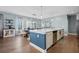 Kitchen and dining area with an island, stainless steel appliances, and hardwood flooring at 127 Crest Brooke Dr, Canton, GA 30115