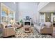Open concept living room with fireplace, tall ceilings, hardwood floors, and a view of the upper level at 127 Crest Brooke Dr, Canton, GA 30115