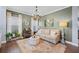 Cozy living room featuring an area rug, a neutral-toned sofa, and a decorative chandelier at 127 Crest Brooke Dr, Canton, GA 30115