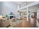 Bright, open living area featuring hardwood floors, a fireplace, and a view to other rooms at 127 Crest Brooke Dr, Canton, GA 30115