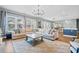 Open-concept living room with a large sectional sofa, an area rug, and lots of natural light at 127 Crest Brooke Dr, Canton, GA 30115
