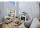 Cozy living room with fireplace, large window, hardwood floors, and comfortable seating at 127 Crest Brooke Dr, Canton, GA 30115