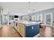 Open floor plan with a large island and sink, great for entertaining in this naturally lit living and dining space at 127 Crest Brooke Dr, Canton, GA 30115