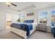 Spacious main bedroom featuring a king bed, tray ceilings, and natural light at 127 Crest Brooke Dr, Canton, GA 30115