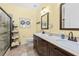 Bathroom featuring double vanity, walk-in glass shower and decorative shelving unit at 1478 Settlers Walk Sw Way, Marietta, GA 30060