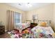Cozy bedroom featuring twin beds, cheerful decor, and a bright floral rug at 1478 Settlers Walk Sw Way, Marietta, GA 30060