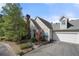 Attractive home exterior features a two-car garage, mature landscaping, and a charming architectural design at 1478 Settlers Walk Sw Way, Marietta, GA 30060