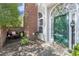 Inviting front entrance with a green door, arched window, and a cozy outdoor seating area at 1478 Settlers Walk Sw Way, Marietta, GA 30060