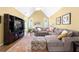 Bright living room with vaulted ceiling, a fireplace, a plush sectional, and an entertainment center at 1478 Settlers Walk Sw Way, Marietta, GA 30060
