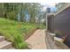 Backyard view featuring stone steps, retaining wall, and patio at 2407 Ridgeway Dr, Doraville, GA 30360