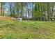 Spacious backyard featuring a storage shed, wooden fence, and ample space for outdoor activities at 2407 Ridgeway Dr, Doraville, GA 30360