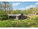 Well-maintained backyard with lush grass, trees, and a house view at 2407 Ridgeway Dr, Doraville, GA 30360