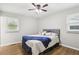 Bright bedroom features hardwood floors, ceiling fan, and natural light from two windows at 2407 Ridgeway Dr, Doraville, GA 30360