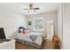 Cozy bedroom offers a ceiling fan, window views, and hardwood flooring at 2407 Ridgeway Dr, Doraville, GA 30360