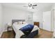 Bedroom featuring hardwood floors, ceiling fan, and a comfortable bed with bedside table at 2407 Ridgeway Dr, Doraville, GA 30360
