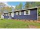 Charming single-story home with blue painted brick and siding, complemented by white shutters at 2407 Ridgeway Dr, Doraville, GA 30360