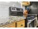 Close-up of the range and granite counter tops in a kitchen at 2407 Ridgeway Dr, Doraville, GA 30360
