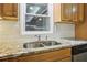 Stainless-steel kitchen sink with tile backsplash and granite countertops at 2407 Ridgeway Dr, Doraville, GA 30360