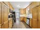 Galley kitchen featuring wooden cabinets, granite countertops and newer appliances at 2407 Ridgeway Dr, Doraville, GA 30360