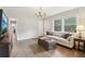 Living room view features hardwood floors, an elegant chandelier, and natural light at 2407 Ridgeway Dr, Doraville, GA 30360