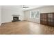 Bright living room with fireplace, hardwood floors, and a built-in cabinet at 2407 Ridgeway Dr, Doraville, GA 30360