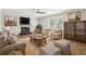 Cozy living room features fireplace, neutral paint, lots of seating, and a decorative area rug at 2407 Ridgeway Dr, Doraville, GA 30360