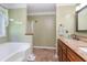 Bathroom featuring a soaking tub, granite countertop vanity, and separate shower at 250 Blackberry Ln, Douglasville, GA 30134