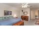 Bedroom with carpet, ceiling fan and featuring a bed, wood furniture, and natural light through the windows at 250 Blackberry Ln, Douglasville, GA 30134